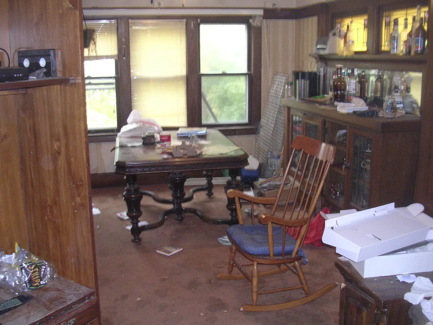 Before — a cluttered, debris-filled room